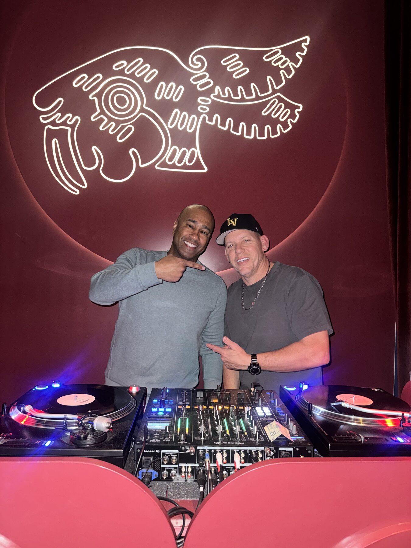 Paki Phillips with a DJ at a club