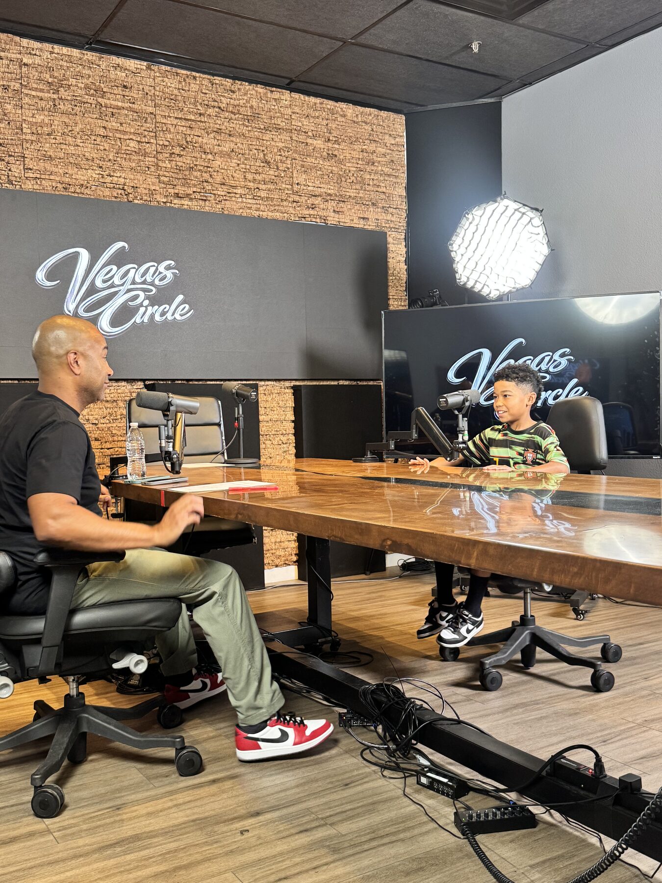 Paki Phillips recording with a young co-host in the Vegas Circle studio