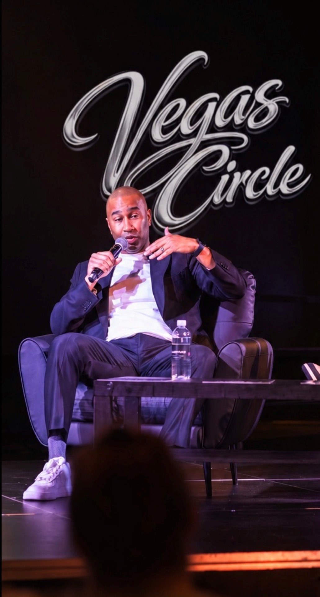 Paki Phillips speaking on stage at a Vegas Circle event