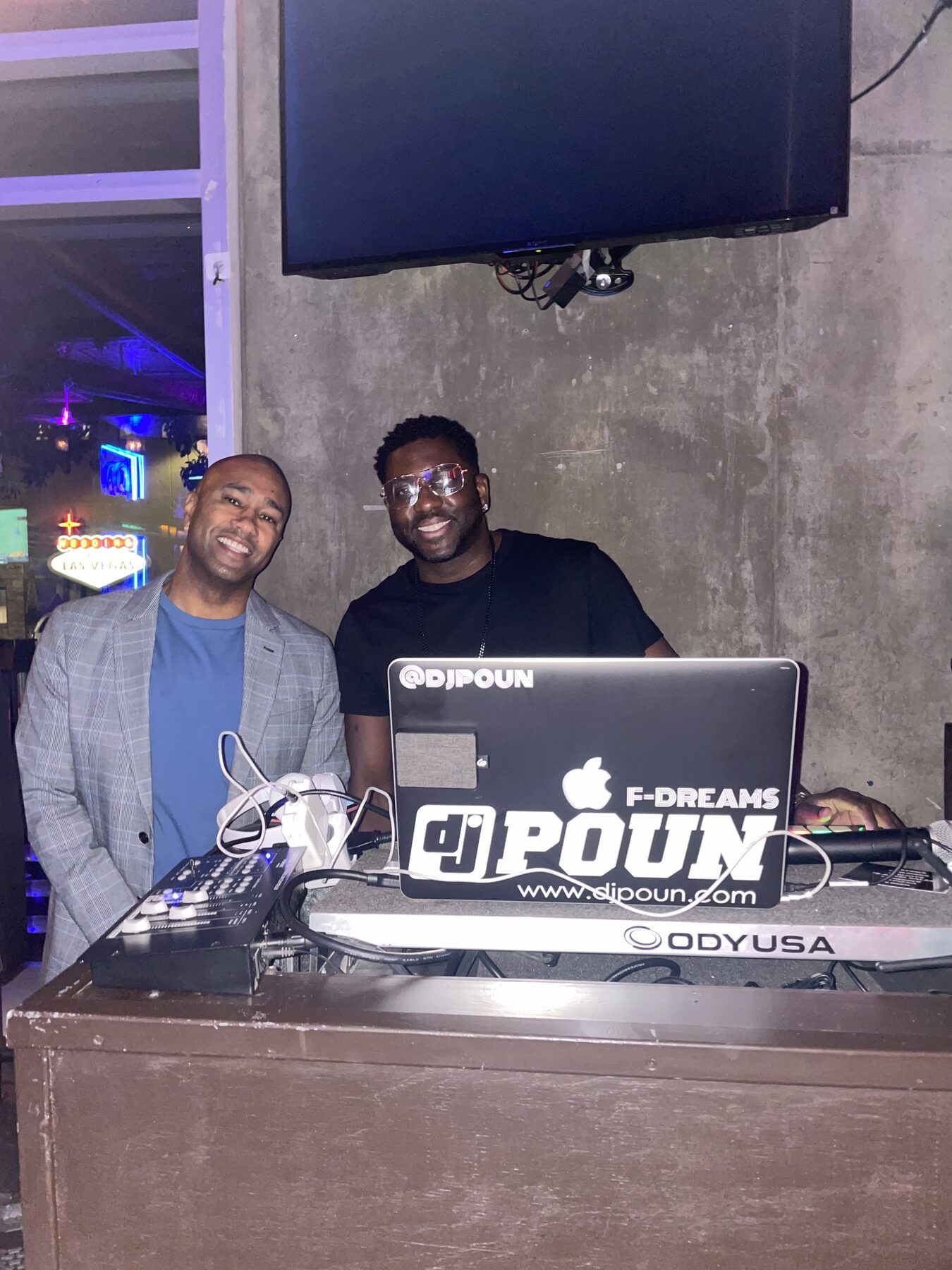 Paki Phillips with a DJ at an event